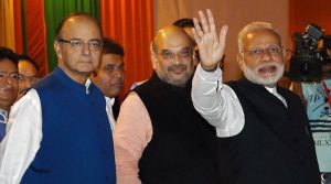 New Delhi : Prime Minister Narendra Modi with BJP President Amit Shah and Union Finance Minister Arun Jaitley during the Diwali Mangal Milan programme at BJP headquarters in New Delhi on Thursday. PTI Photo by Manvender Vashist(PTI11_3_2016_000327B)